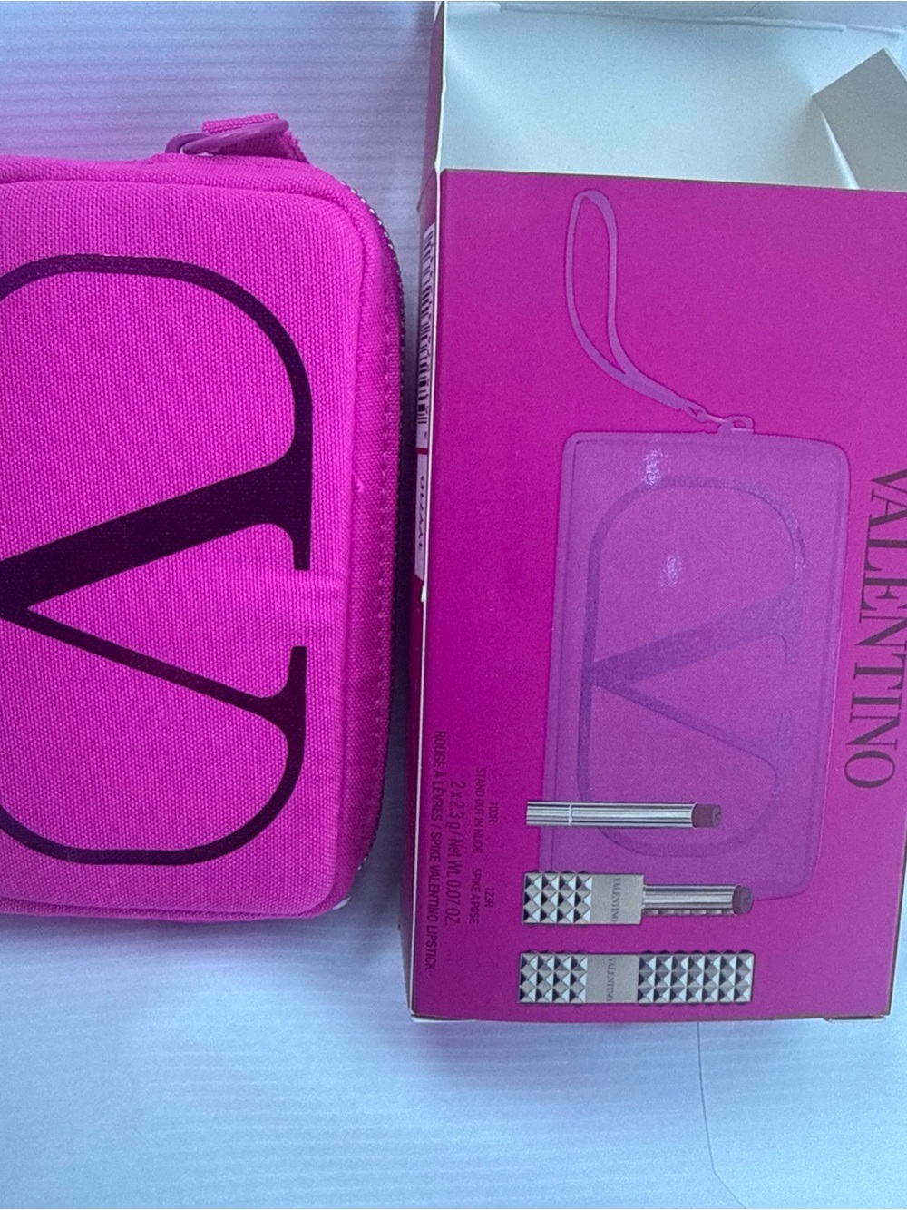 Valentino Bright Pink Logo Cosmetic Pouch with two shades of lipstick